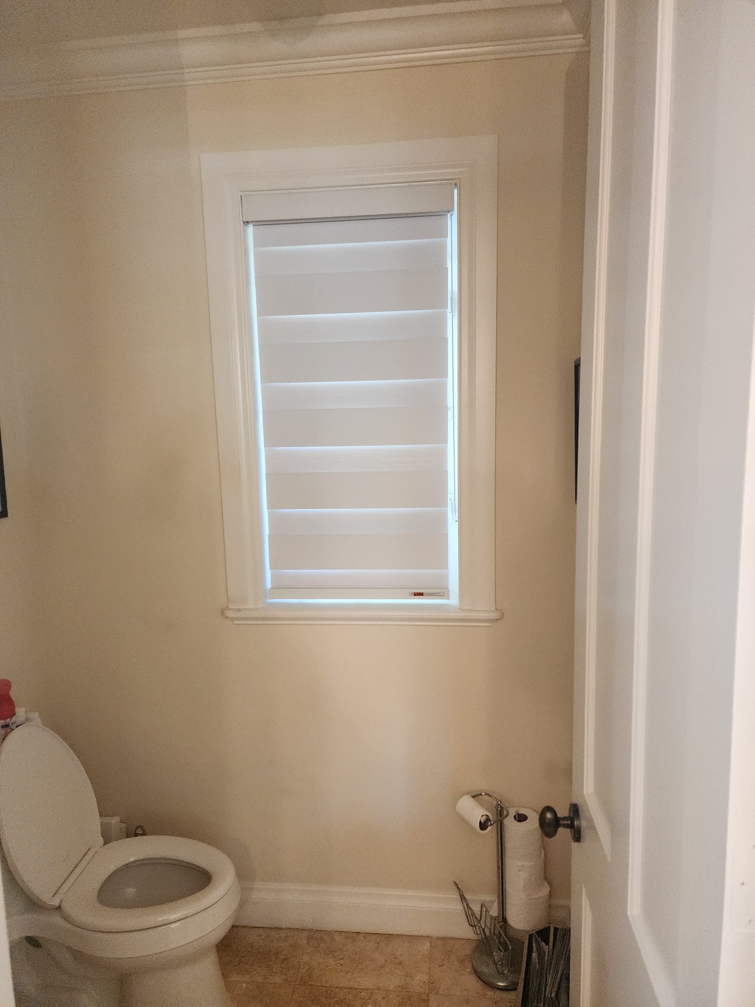 White zebra shade in a powder room