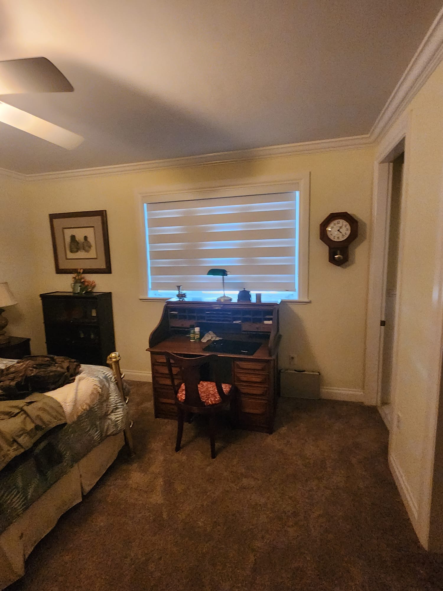 Zebra shades over a bedroom writing desk
